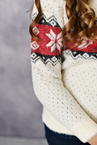 Girls ivory crew neck sweater with   red and black winter detail.