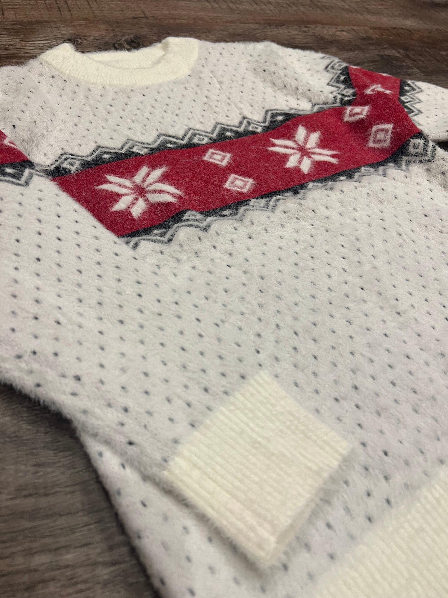 Girls ivory crew neck sweater with   red and black winter detail.